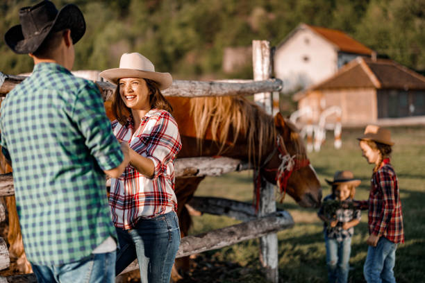 istock Happy parents enjoying in conversation during spring day on a farm. 1249176052