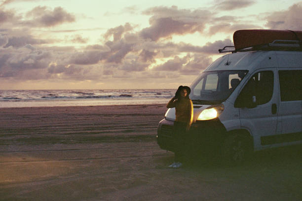 istock Woman standing near camper van   on beach in Denmark 1249176080