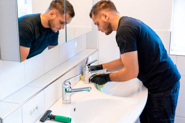 istock man cleaning a bathroom sink with a scraper blade and micro fiber cloth to remove lime and stains 1249180253