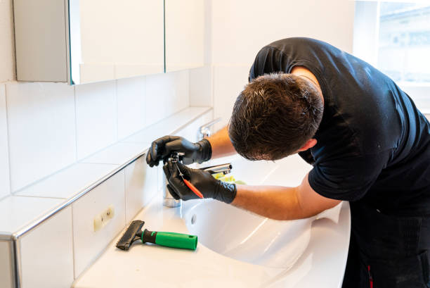 istock man cleaning a bathroom sink with a scraper blade and micro fiber cloth to remove lime and stains 1249180285