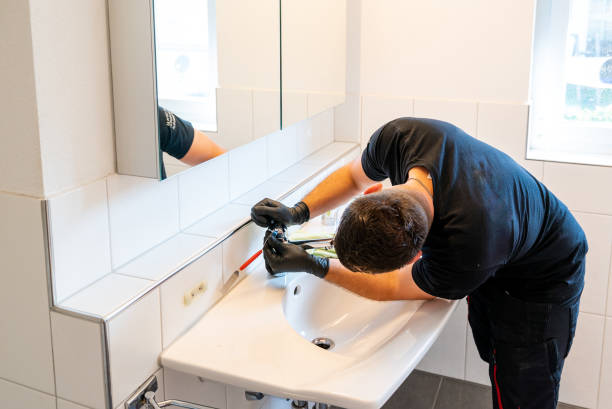 istock man cleaning a bathroom sink with a scraper blade and micro fiber cloth to remove lime and stains 1249181457