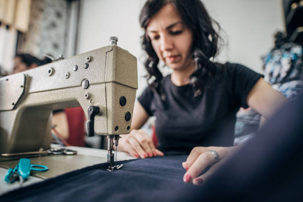 istock One young woman working on a sewing machine in tailor workshop 1249181738
