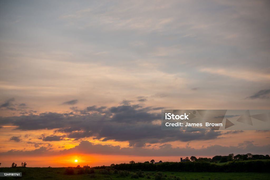 Sunset over the hamlet of Billy, near Bushmills Sunset over the hamlet of Billy, near Bushmills, Causeway Coast, County Antrim, Northern Ireland Agricultural Field Stock Photo