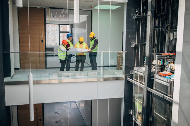 istock Engineers and architects looking at building blueprint at the construction site 1249186098