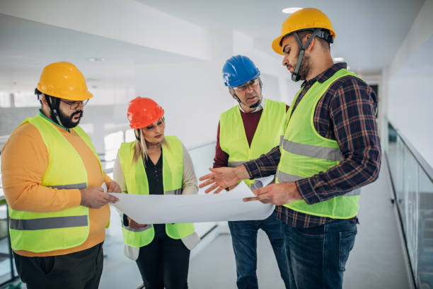istock Engineers and architects looking at building blueprint at the construction site 1249186216