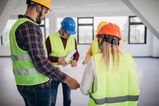 istock Engineers and architects looking at building blueprint at the construction site 1249186236
