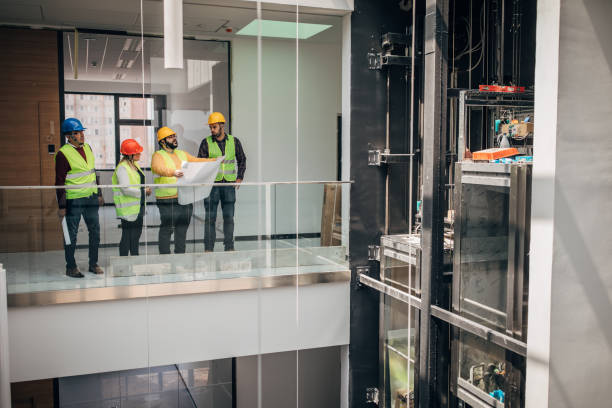 istock Engineers and architects looking at building blueprint at the construction site 1249186395