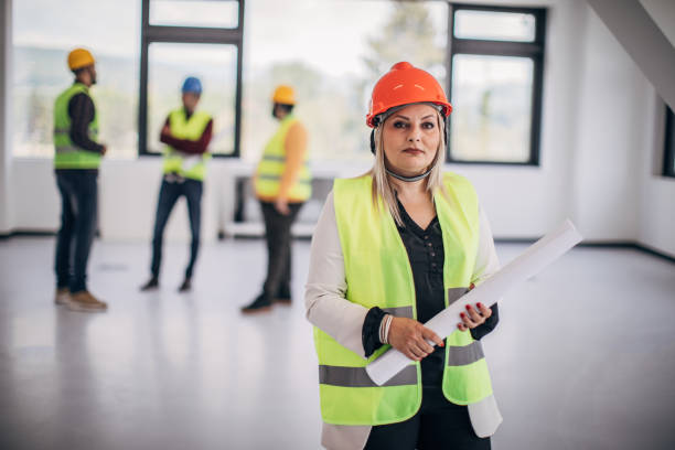 istock Female architect with her colleagues at the construction site 1249186443