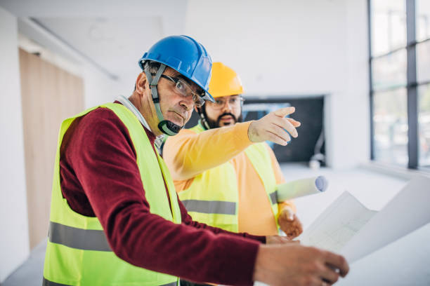 istock Male architects looking at building plan at the construction site 1249186523