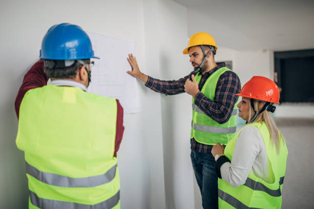 istock Engineers and architects looking at building blueprint at the construction site 1249187584