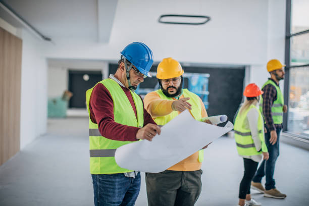 istock Male architects looking at building blueprint at the construction site 1249188146
