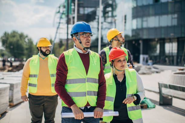 istock Engineers and architects walking at the construction site outdoors 1249189306