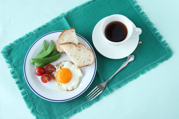 fried eggs - breakfast images fried eggs - breakfast images egg cherry tomato rye stock pictures, royalty-free photos & images