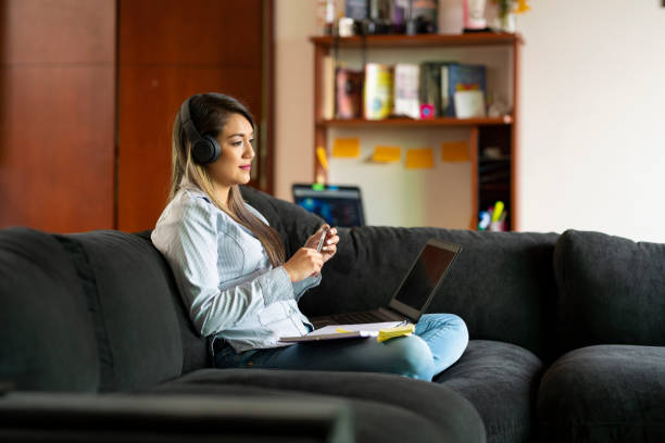 istock Young Woman Performs Her Homework From College From The Sofa At Home 1249194994