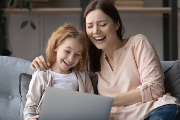 istock Overjoyed mom and little daughter using laptop together 1249199770