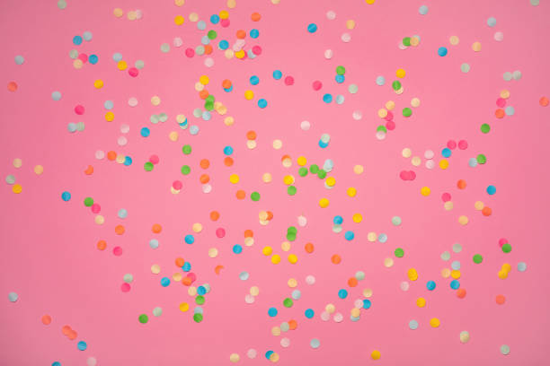 istock Pink background with vivid confetti. Colorful abstract backdrop with scattered paper circles. Beautiful decor for the party. Festive composition for celebration. View from above. Flat lay. 1249200406