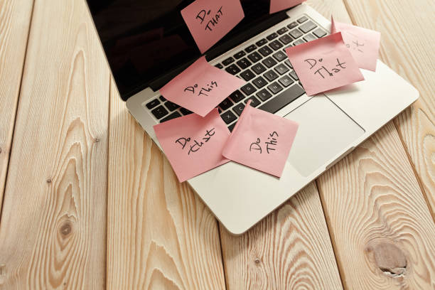istock Image of laptop full of sticky notes reminders on screen. Work overload concept image. Coworking or working at home concept image. 1249200485