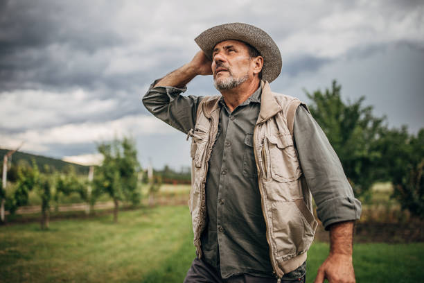 istock One man standing in the field and hoping that it will rain 1249200895