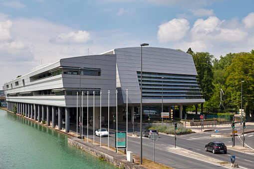 Reims, France - June 09 2020: The Reims convention center (French: Palais des congrès de Reims) alongside the Aisne to Marne canal.