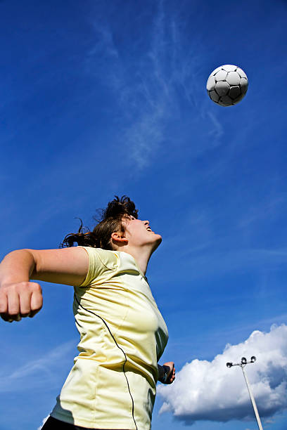 istock Woman soccer or football player header 124920157