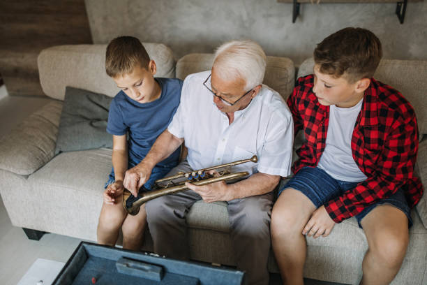 istock Grandfather teaches how to play trumpet 1249201705