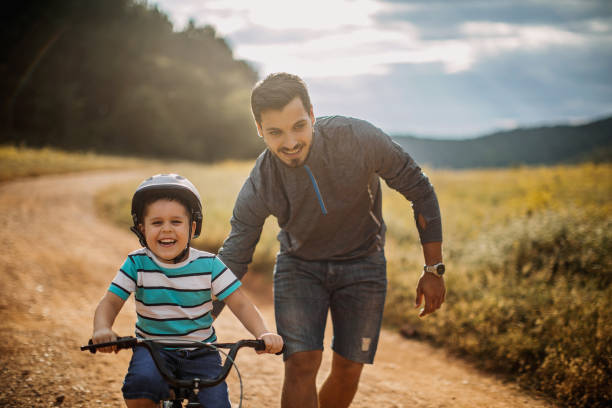 istock Father teaches son to ride a bike 1249201731