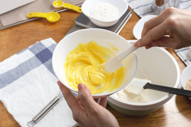 istock Butter in bowl mixing with spatula in hand 1249201909