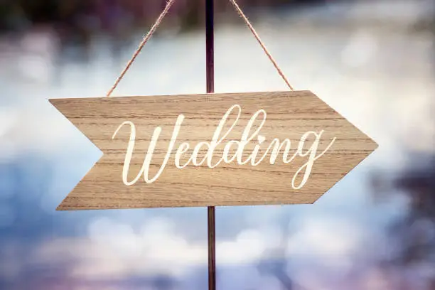 Photo of Wedding ceremony wooden arrow location sign