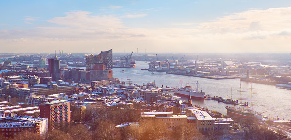 Scenic panorama view from Dancing Towers over Hamburg under snow in winter with Speicherstadt, harbor warehouses and New Elbe Philharmonic Theater, Elbphilharmony.