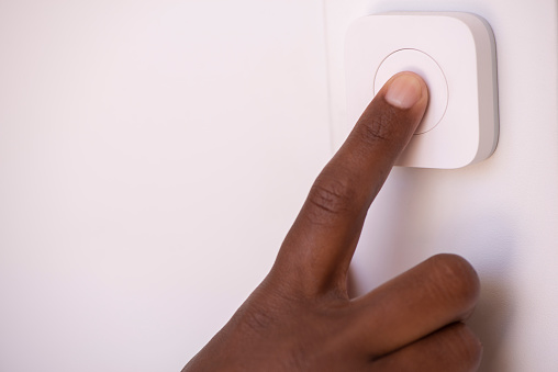 Close up image of a female's index finger pressing the electric switch button.