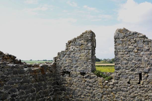 istock Picturesque derelict stone cottage on a pebble beach 1249218078