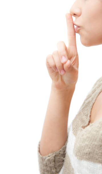 istock Unrecognizable woman asking for silence with finger on lips 1249219321
