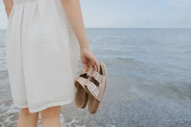 Photo of woman with beach slippers