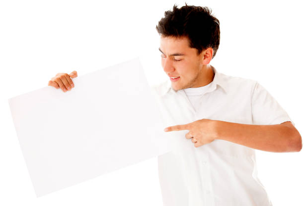 istock Young man pointing at a blank banner 1249220013