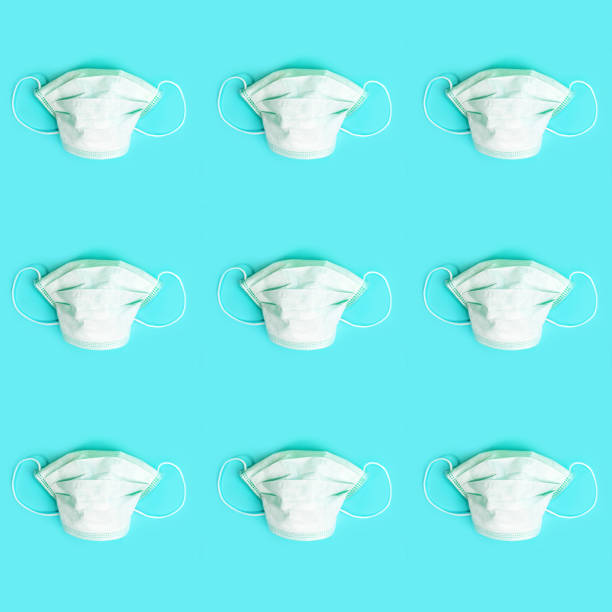 istock Pattern made of medical masks on pastel blue background. 1249220138