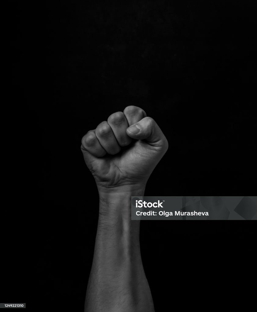 Fist raised up. Human hand. Fist raised up. Protest Against Racism. Fist Stock Photo