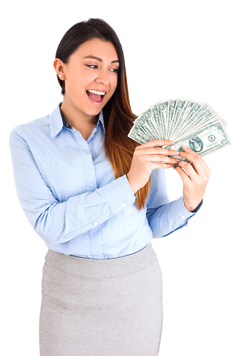 Young woman looks very happy holding a bunch of bills. She is dressed in formal clothes and smiling