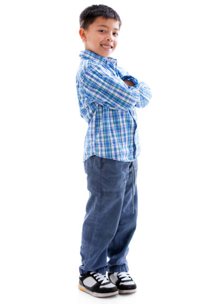 Successful little boy smiling at camera with arms crossed - Studio shot