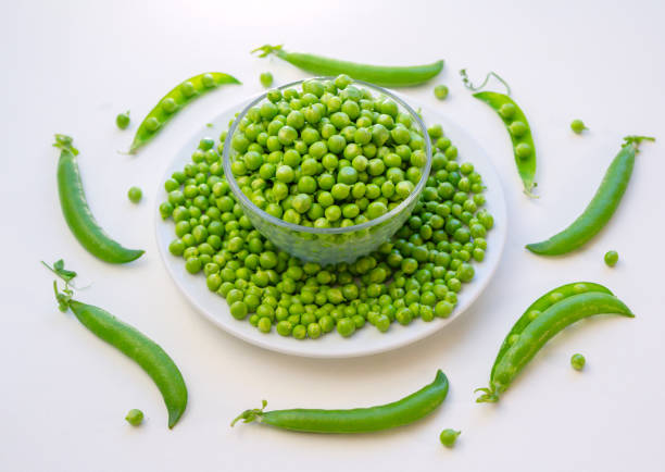 istock Close up fresh green peas in a glass bowl 1249221834