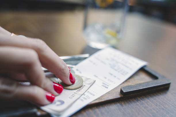 istock Giving tips on bill in coffee shop 1249221930