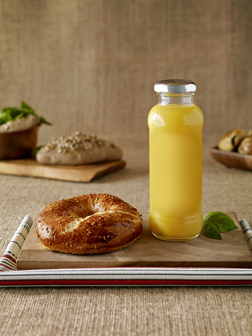 Baked pastry and orange juice on a wooden table top