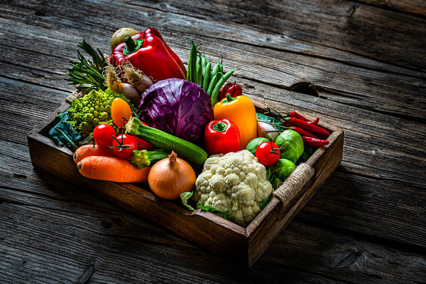 istock Healthy fresh vegetables in a crate on wooden table 1249223923