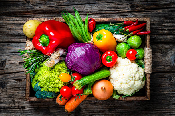 istock Healthy fresh vegetables in a crate on wooden table 1249223926