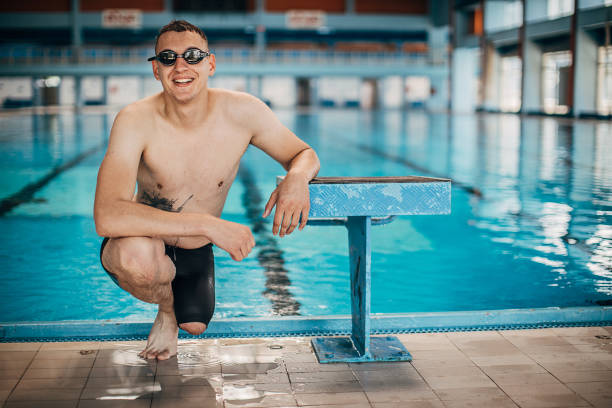 Male swimmer isolated on black