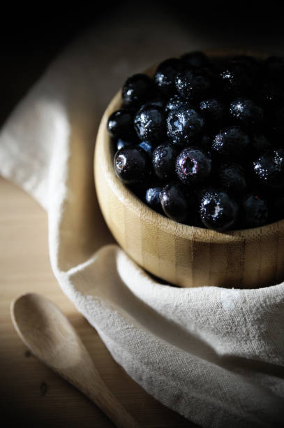 istock Fresh blueberries in a bamboo bowl on a wooden table. 1249227111