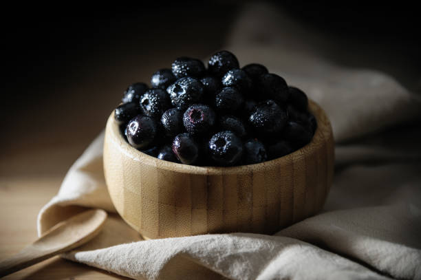 istock Fresh blueberries in a bamboo bowl on a wooden table. 1249227792