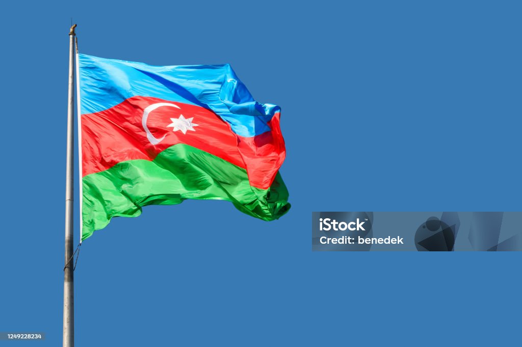 Flag of Azerbaijan Flag of Azerbaijan against blue sky on a sunny day. Azerbaijan Stock Photo