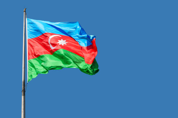 Flag of Azerbaijan Flag of Azerbaijan against blue sky on a sunny day. azerbaijan stock pictures, royalty-free photos & images