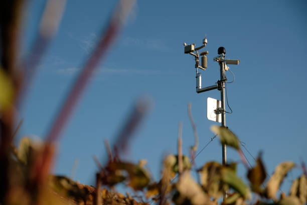 Small weather station with webcams on metal pole against blue sky stock photo