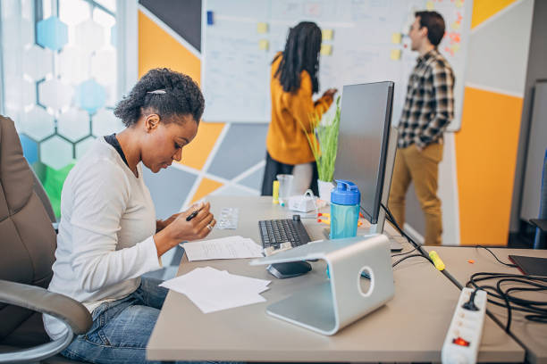 istock Three business people working together in big modern office 1249232066